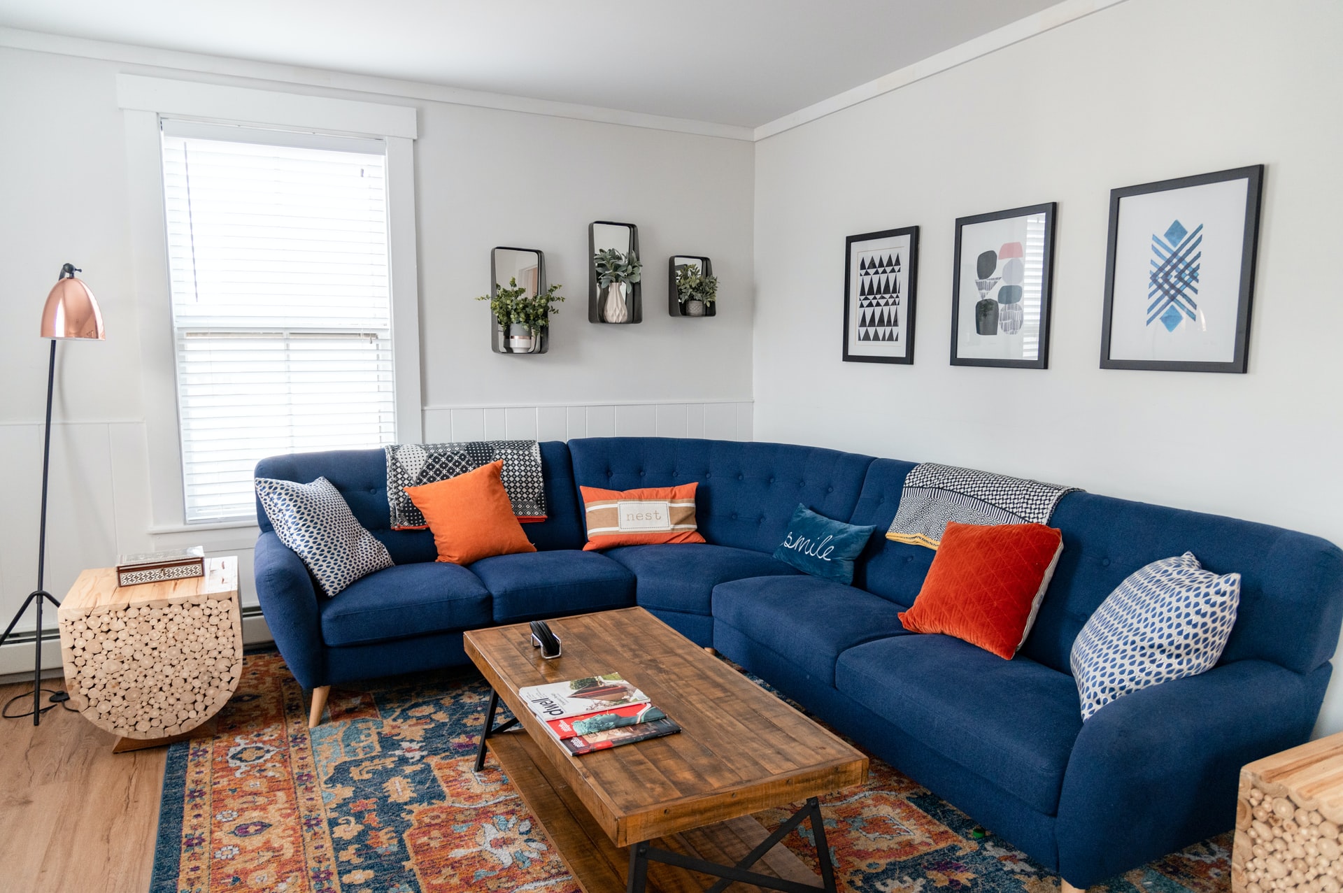 tag: a living room with a blue sectional and white walls