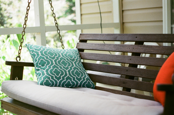 front porch swing says welcome for curb appeal